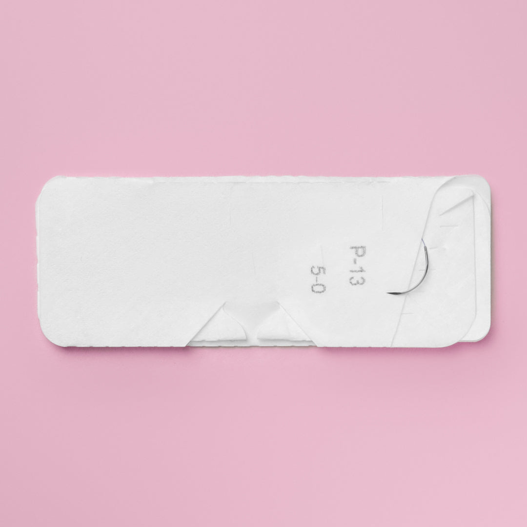 Image displaying Covidien's CAPROSYN Monofilament Absorbable Suture box, model SC5587G, in violet. The box highlights key information such as suture size 5-0, needle type P-13 reverse cutting, and suture length of 18 inches, with symbols indicating its absorbable nature and monofilament composition.