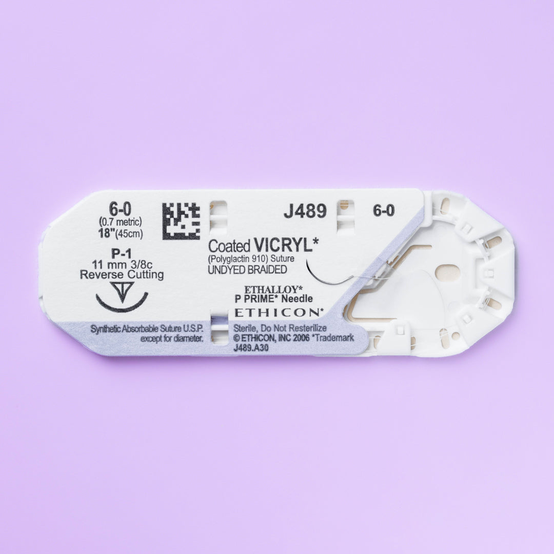 Box of COATED VICRYL® 6-0 Undyed Sutures, model J489G, featuring fine sutures with an 11mm P-1 prime reverse cutting needle, tailored for precision in delicate surgical contexts. The packaging highlights the absorbable nature and surgical versatility of these sutures, ideal for enhancing patient outcomes.