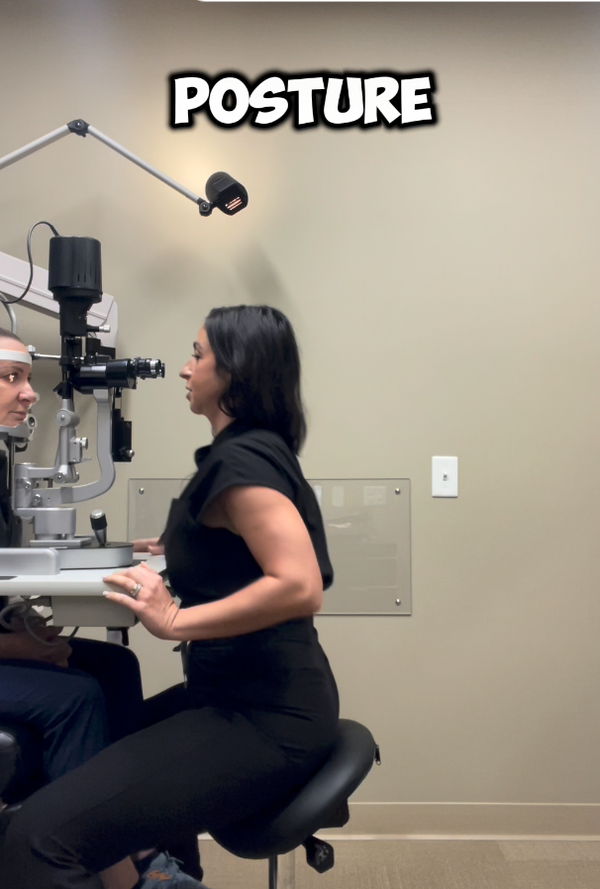 Clinician at a slit lamp on a saddle stool