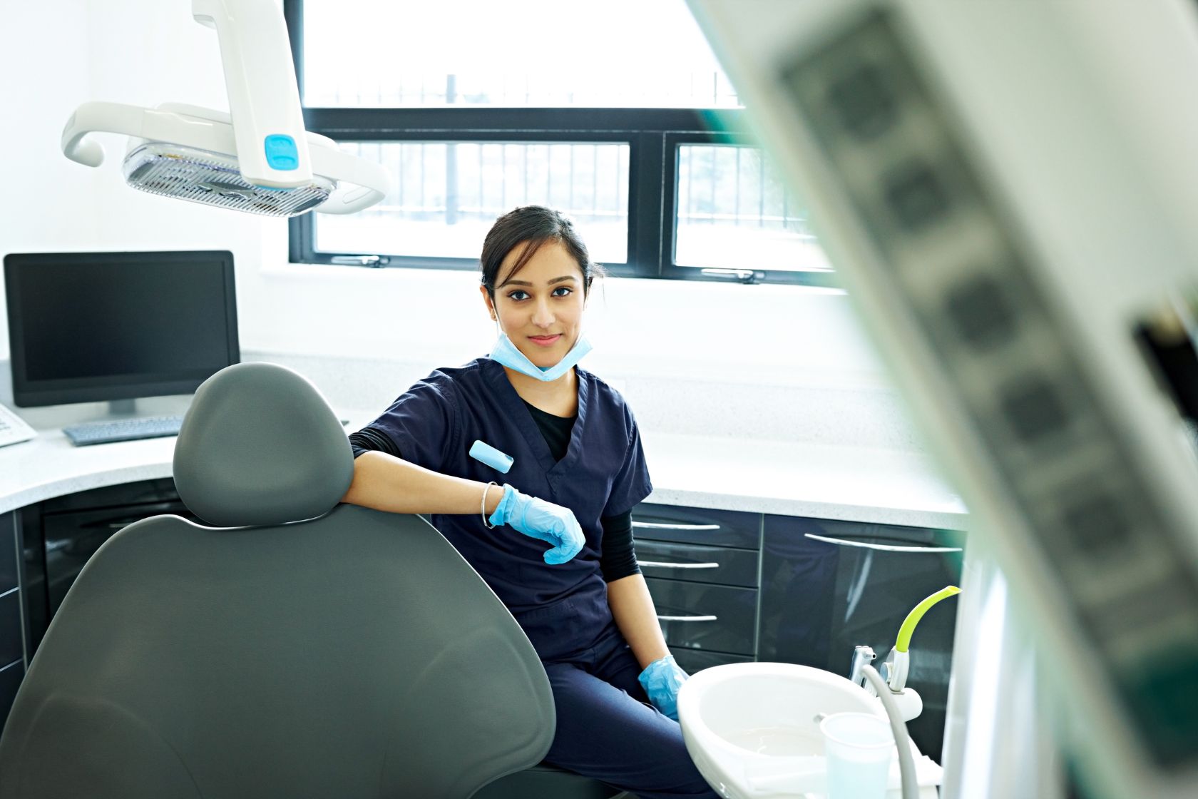 dentist using a saddle stool