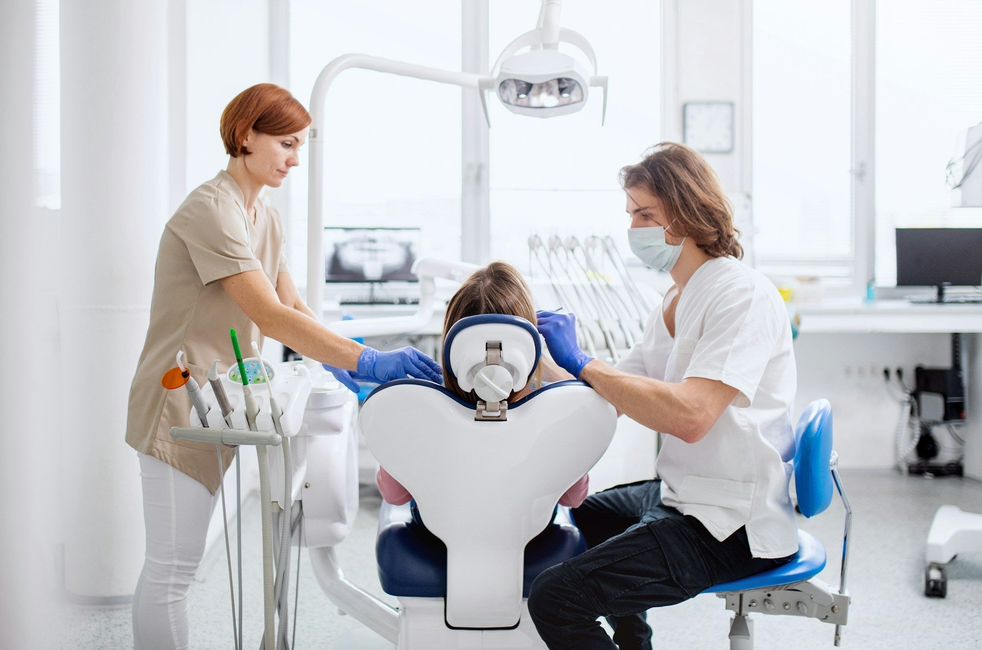 dentist sitting on a saddle stool
