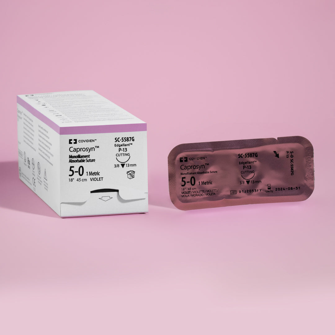 Image displaying Covidien's CAPROSYN Monofilament Absorbable Suture box, model SC5587G, in violet. The box highlights key information such as suture size 5-0, needle type P-13 reverse cutting, and suture length of 18 inches, with symbols indicating its absorbable nature and monofilament composition.