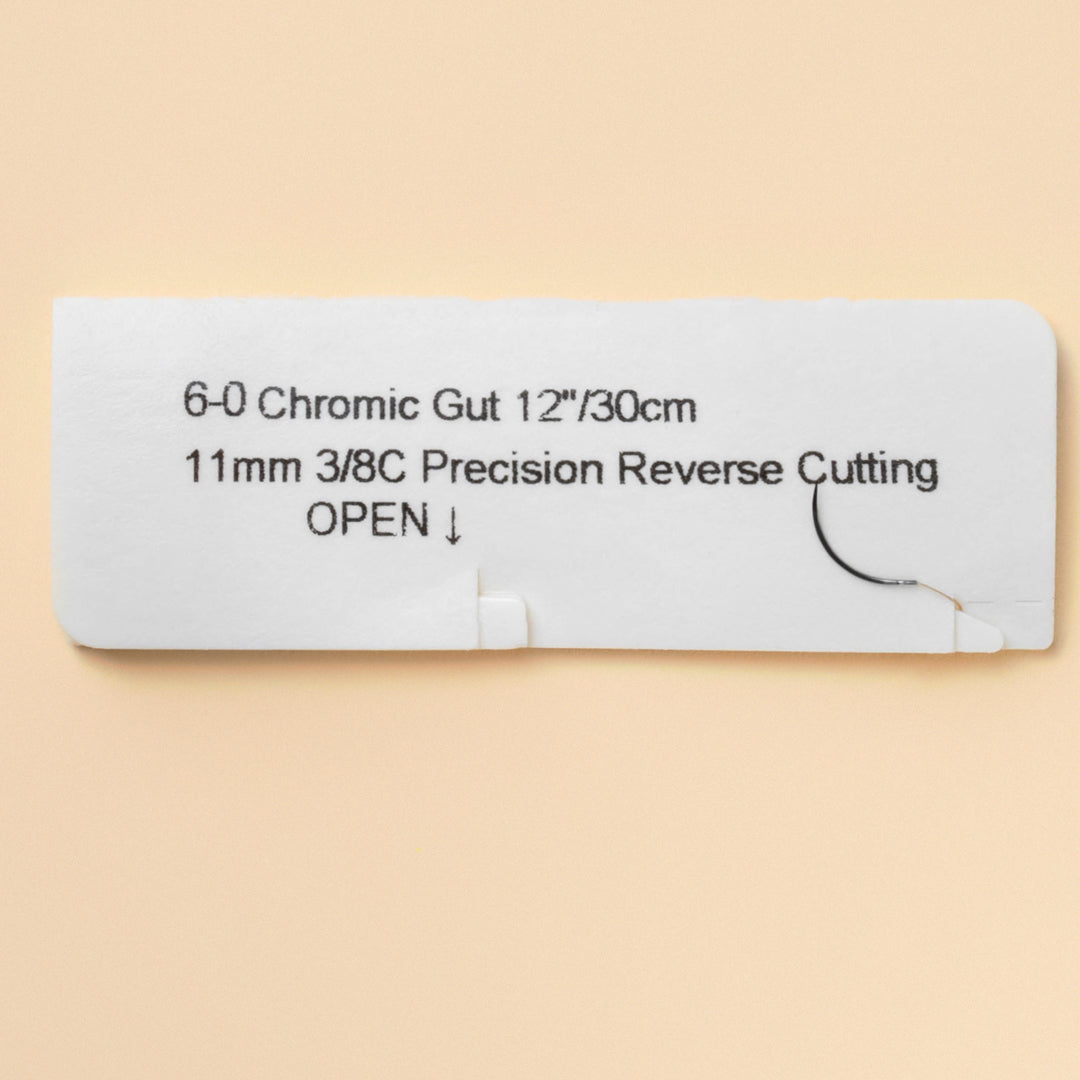 Box of 6-0 Chromic Gut sutures with a C1 precision reverse cutting needle, model 1242B, emphasizing the 2-week wound support duration and featuring a QR code for easy reference. The packaging highlights its sterility and absorbable nature tailored for delicate surgical procedures.