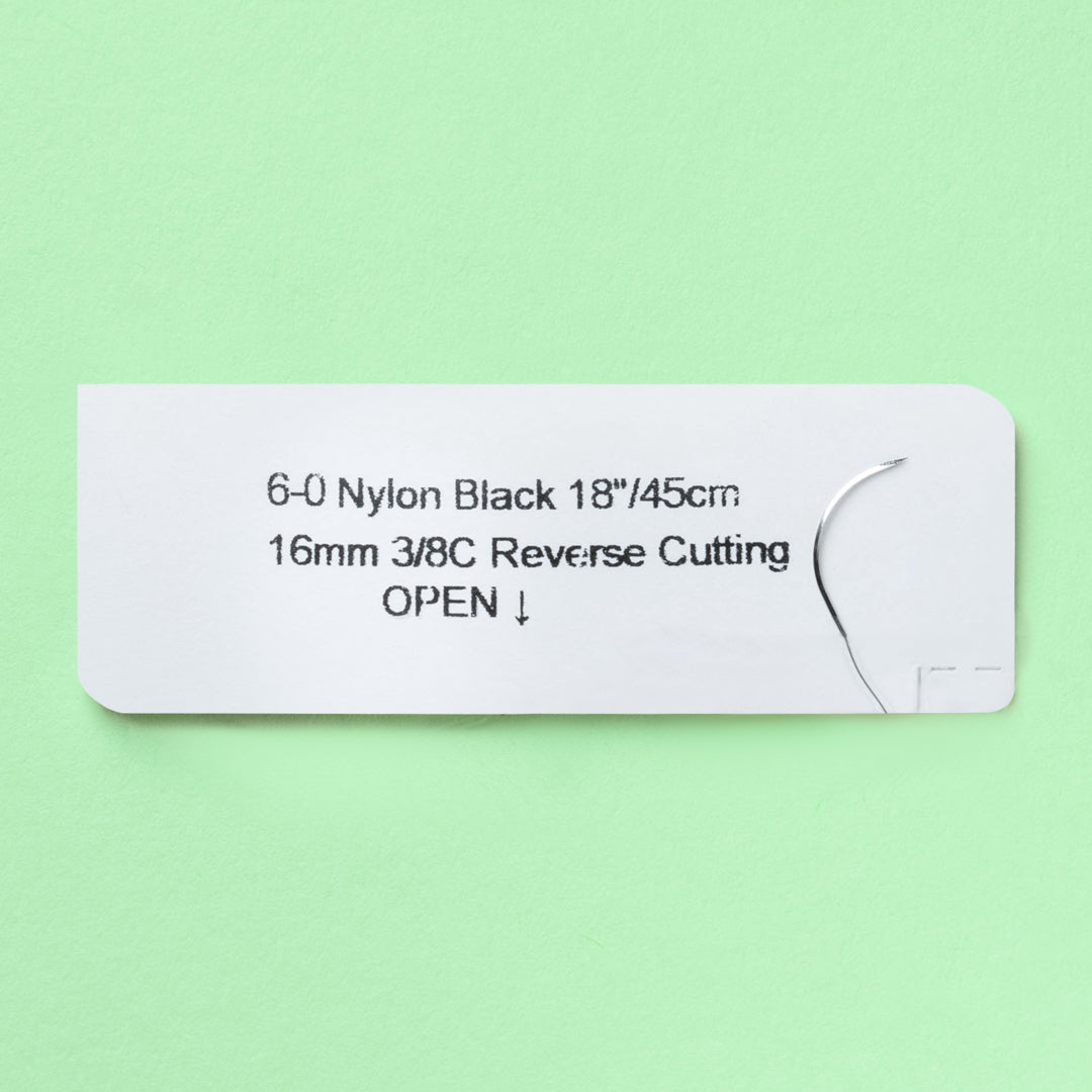 Box of LOOK™ 6-0 Nylon Black sutures featuring a C22 reverse cutting needle, product number 915B, highlights its non-absorbable nature and is designed for long-term wound support. The packaging includes a QR code for easy product identification and emphasizes the suture's durability and smooth passage through tissue.