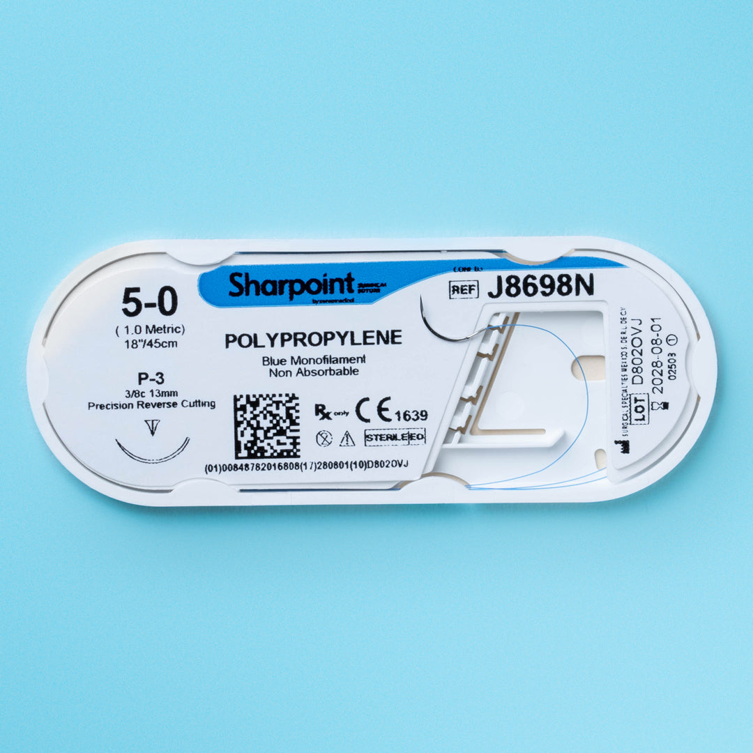 A box and individual packet of Sharpoint 5-0 blue polypropylene suture (J8698N) with an 18-inch length and a P-3 precision reverse cutting needle, ideal for detailed surgical applications. The non-absorbable monofilament suture is highlighted for its use in dental and cosmetic surgeries, emphasizing its high-quality manufacture and suitability for procedures requiring exceptional suturing precision.