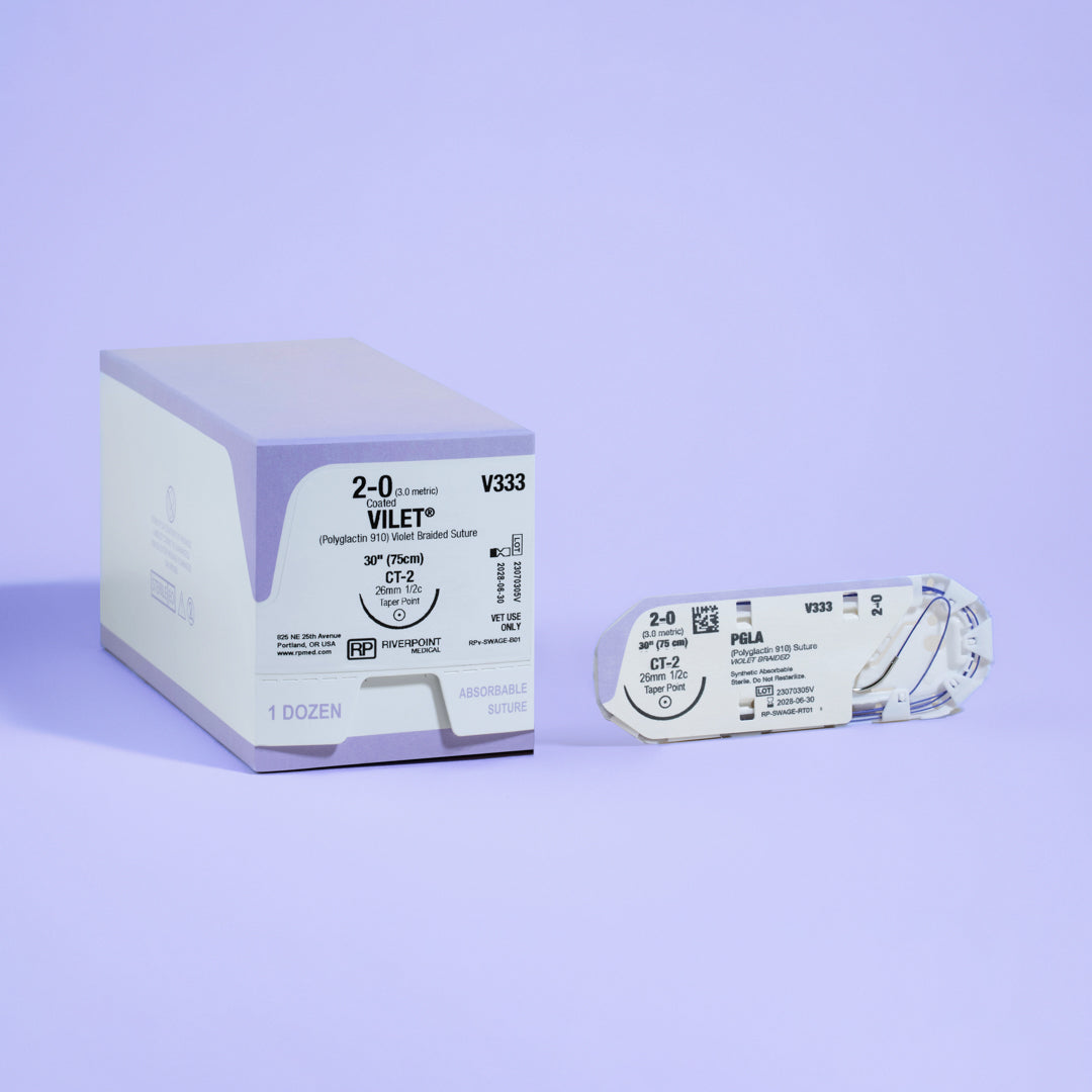 Photograph displaying the 2-0 VILET® Violet 30" CT-2 Needle (V333) box next to its open sterile packaging, illustrating the product's specifications and its readiness for use in veterinary surgical procedures, produced by Riverpoint Medical