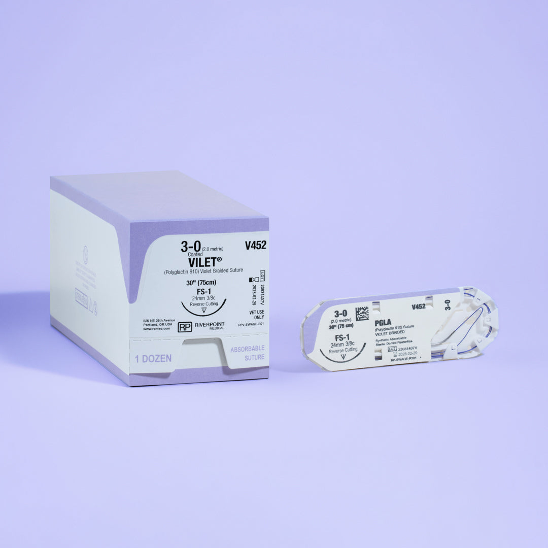 Photograph featuring the 3-0 VILET® Violet 18" FS-1 Needle (V452) box next to its open sterile packaging, illustrating the product's specifications and readiness for use in veterinary surgical practices, produced by Riverpoint Medical